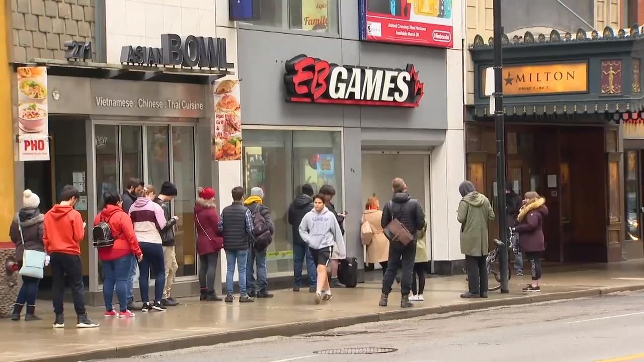 People gather for game release outside Toronto EB Games despite social
